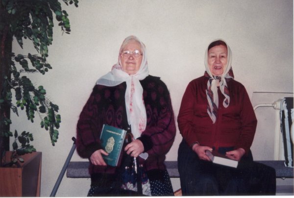 Two women after Friday prayer with their copies of the Quran